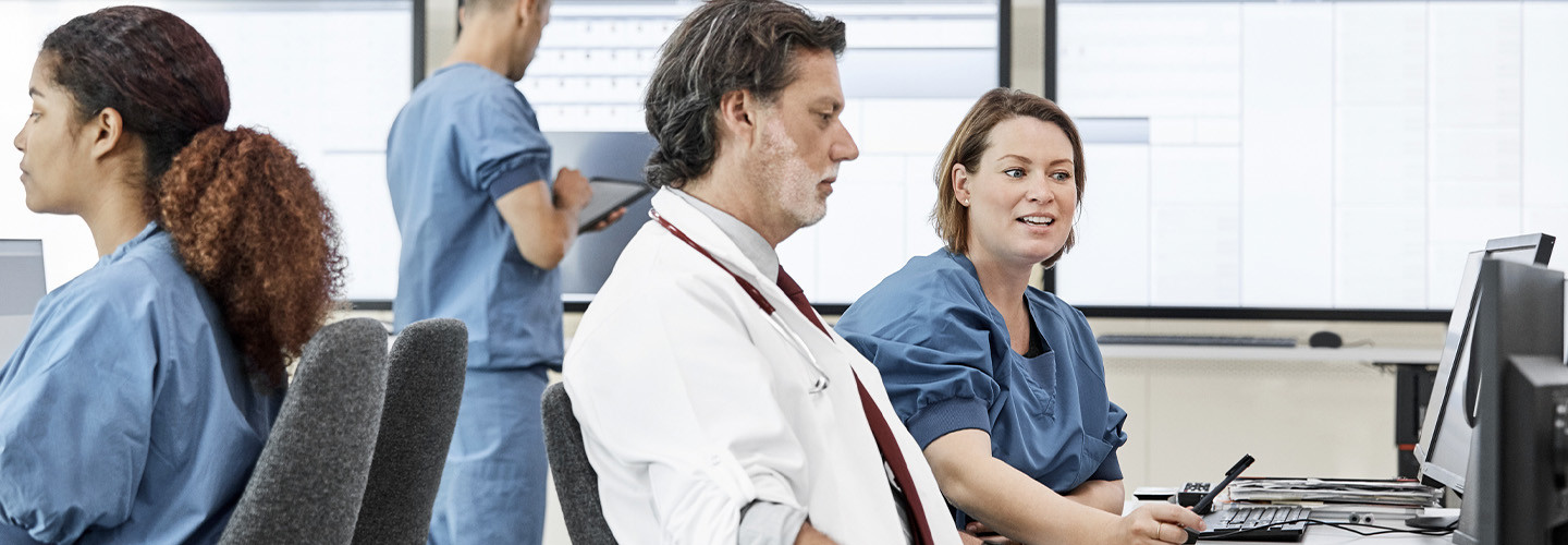 Medical professionals working in control room