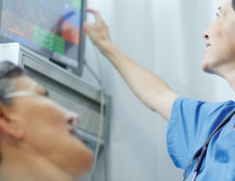 nurse checks on patient's vitals