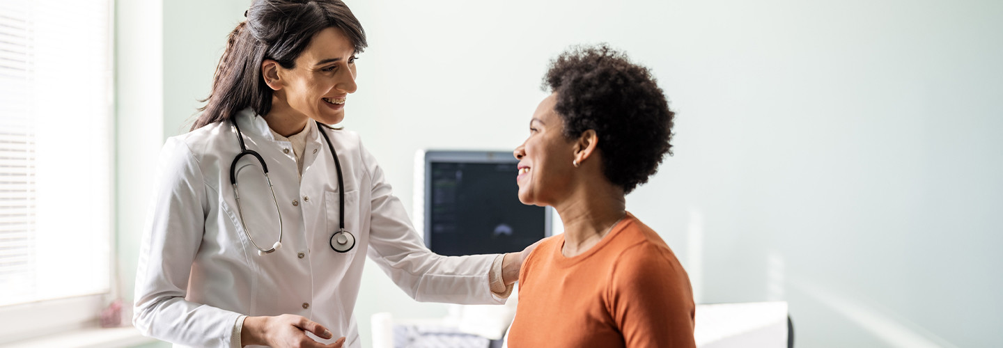 Doctor speaking to middle age woman