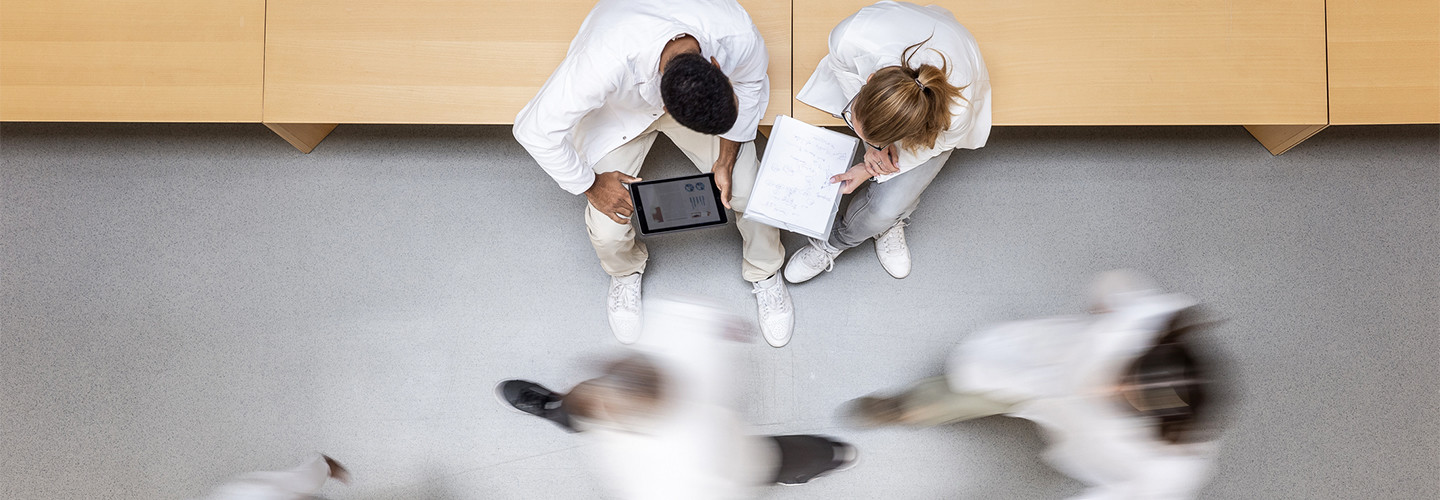 Doctors using devices in a hospital