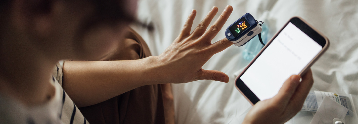 Person using mobile device to take their pulse